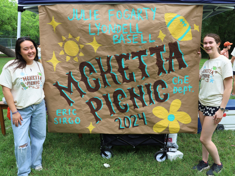 Outgoing Texas AIChE leaders pose with McKetta Picnic Sponsor Appreciation Banner